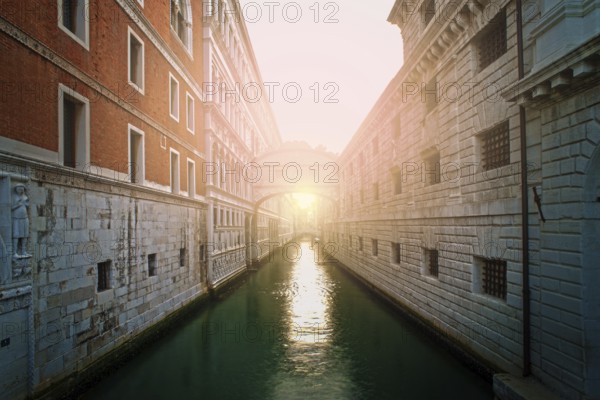 Ancient buildings and boats in the channel in Venice. Restaurant on foreground