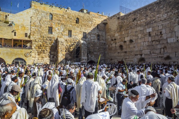 JERUSALEM, ISRAEL - SEPTEMBER 26, 2018: The blessing of the Cohanim. Jews praying wrapped in festive white Talit. Exciting festive ceremony at the Western Wall of the Temple. The concept of pilgrimage