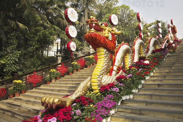 Traditionally decorated ladder in the Chinese park - a red dragon and bright flowers