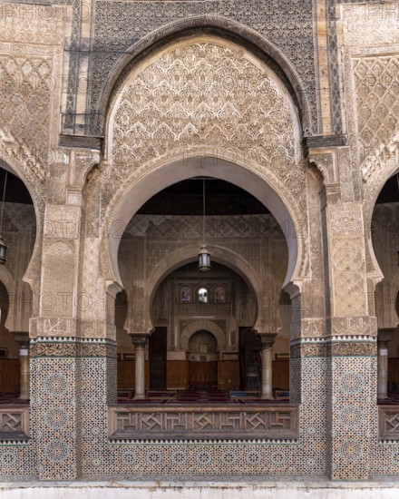 Fes, Morocco, April 05, 2023, Traditional oriental facade at the courtyard of madrasa Bou Inaniya in the medina of Fes, Morocco