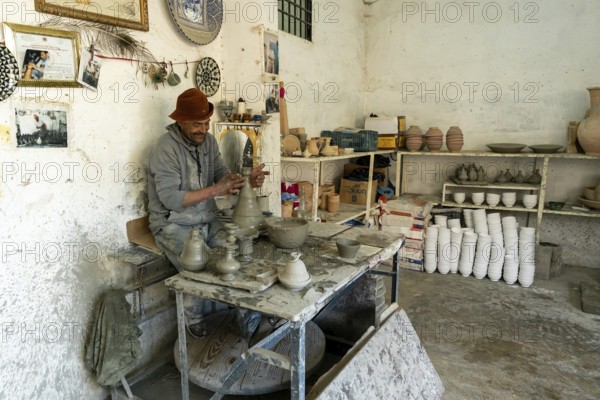 Fez, Morocco, 4 March, 2024: Moroccan potter at work in his pottery studio in downtown Fez northern inland Morocco