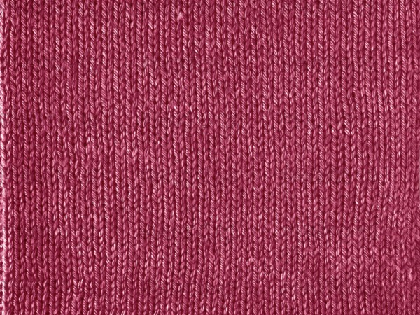 Viva Magenta color knitted Jersey as textile background. Knitted Red Magenta texture. Color of the year 2023 concept