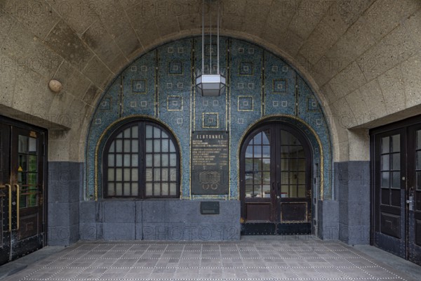 Arched entrance with decorative tiles and an information board, entrance to the St. Pauli Elbe Tunnel, Hamburg harbour, Free and Hanseatic City of Hamburg, Germany