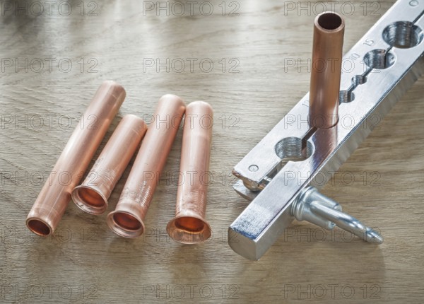 Flared pipes brake plumber on wooden board