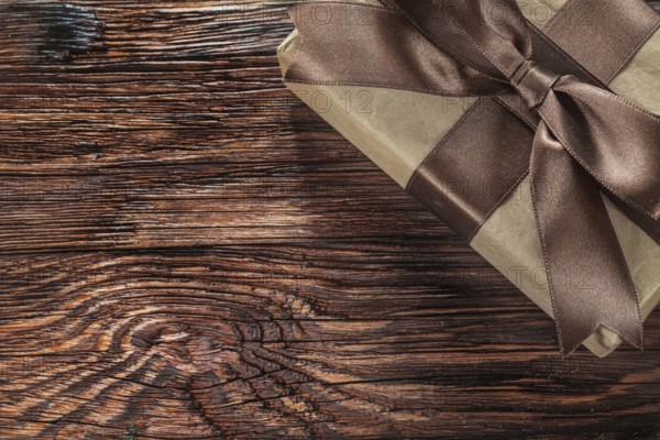 Brown gift box on vintage wooden board