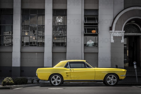 Vintage car parking in front of an Art Deco building in downtown Napier, North Island of New Zealand