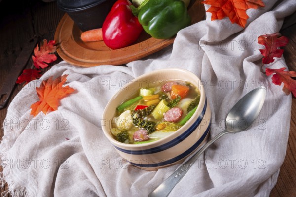 Delicious autumn vegetable soup with sausage and bacon
