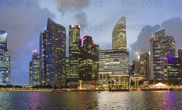 Singapore skyline at night. Buildings along Marina Bay