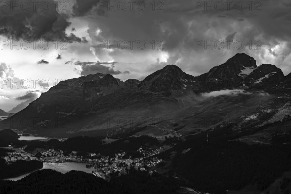 Beautiful Aerial View over Alpine Lakes and Swiss Alps and Cityscape in Sunset and Storm Clouds over St Moritz, Maloja, Grisons, Switzerland