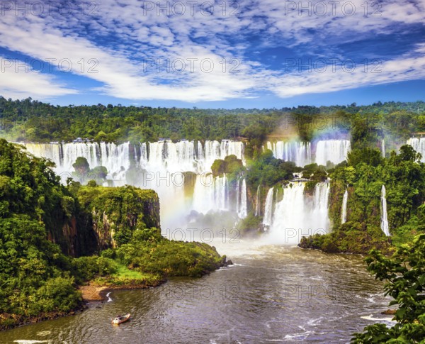 Concept of active and extreme tourism. Incredible exotic waterfalls of Iguazu in South America, on the border of three countries: Brazil, Argentina and Paraguay
