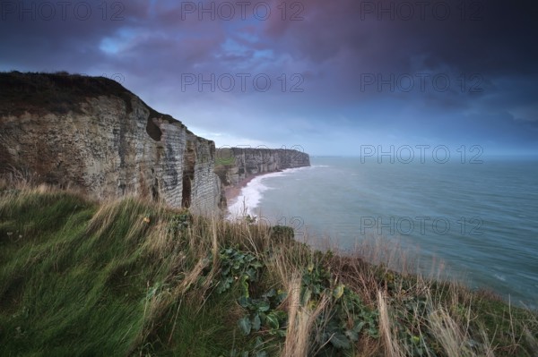 Sunrise over cliff in ocean, Etretat, Normandy, France