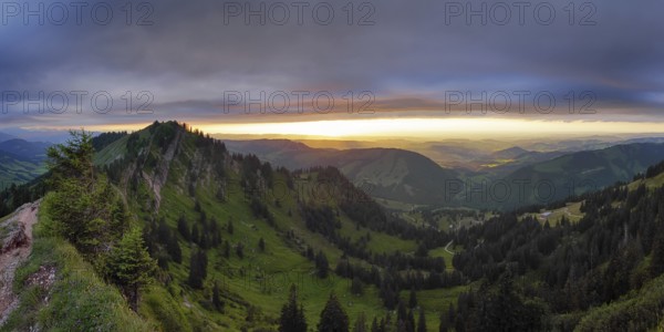 Panoramic view of a light and weather scene over the foothills of the Alps, taken from the Nagelfluhkette, Allgäu. In the centre in the background Oberstaufen and on the left the Seelekopf