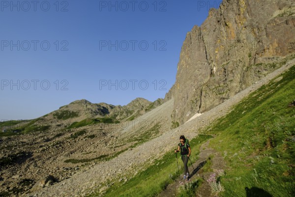 Hiker on the road, Midi d'Ossau peak, 2884 meters, Pyrenees National Park, Pyrenees Atlantiques, France