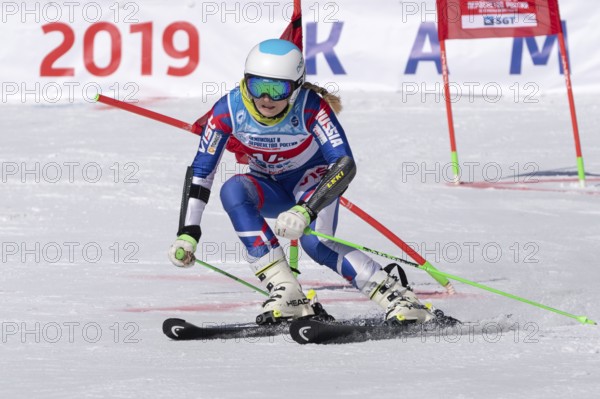 MOROZNAYA MOUNT, KAMCHATKA PENINSULA, RUSSIA, MARCH 30, 2019: Russian Federation Alpine Skiing Championship, parallel slalom. Mount skier Ksenia Fedorova Moscow skiing down mountain slope