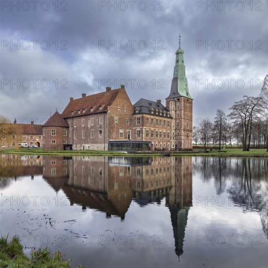 Water castle Raesfeld in Muensterland, North Rhine-Westphalia, Germany. View with reflection in the lake