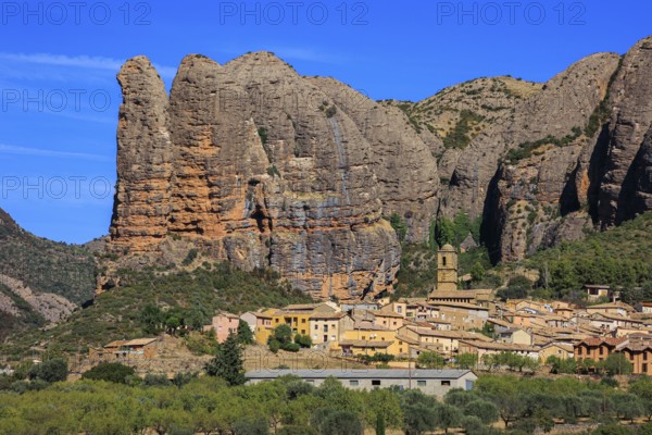 Aguero village at the foot of the dangerous and magnificent Mallos cliffs. Province of Huesca, Aragon. Romantic trip to northern Spain. The magical nature of Spain