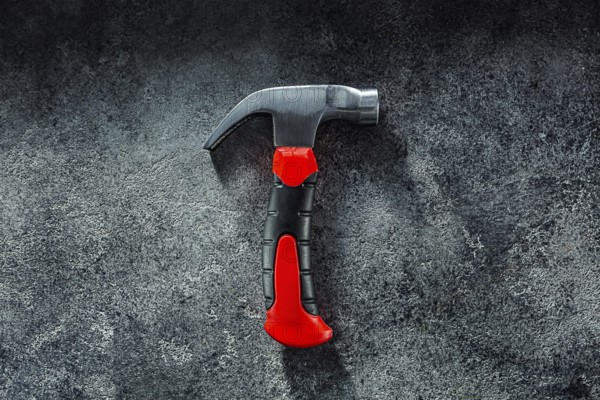 Black Little Claw Hammer On Dark Grey Background