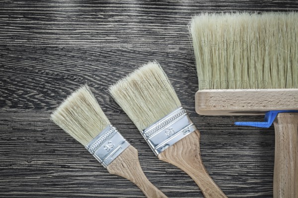 Paint brushes on wood board top view
