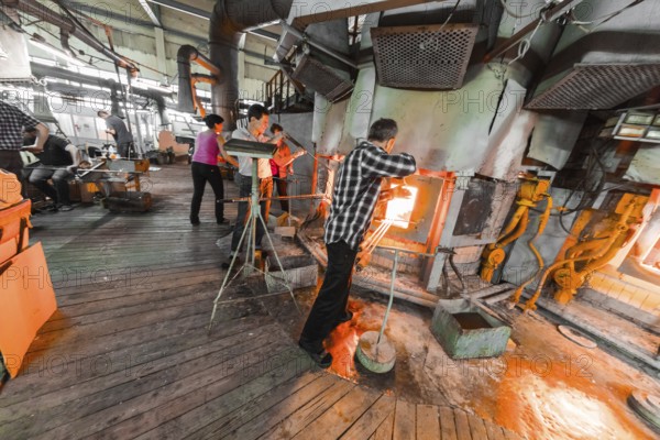 Belarus, Minsk, - March 01, 2018: Neman Glass factory. Glass factory workers on manufacture background working with industry equipment