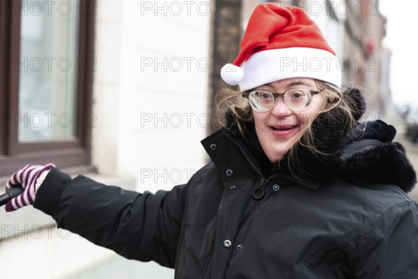 Happy 39 year old woman with Down Syndrome with a christmas cap, Tienen, Hakendover