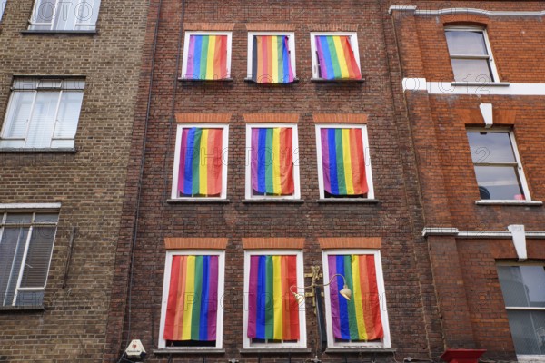 A wall with rainbow flags for LGBT community in Soho area in London, United Kingdom