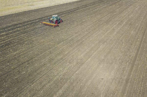 Farmer seeding crops at field. Seeding Aerial View