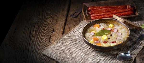 Rustic sauerkraut soup with bacon and sausage
