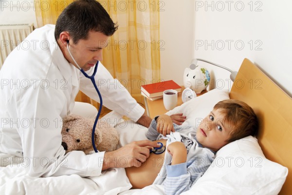A doctor on a house call. Examining a sick child. Austria