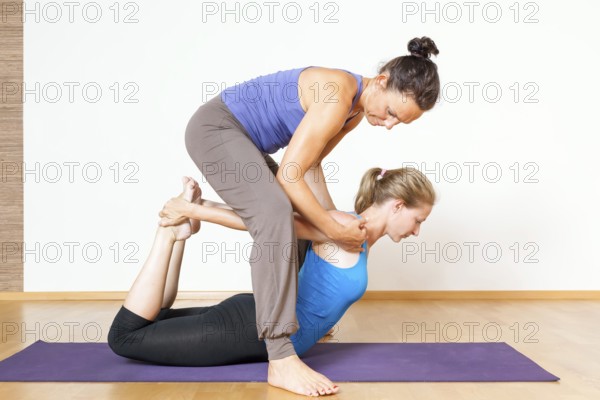 An image of some people doing yoga exercises