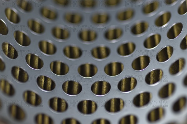 Detail of a tractor oil filter creates an industrial textured background
