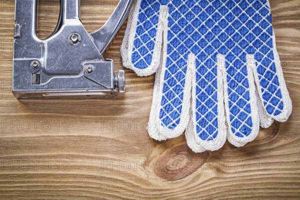 Collection of construction forklift safety gloves on wooden board