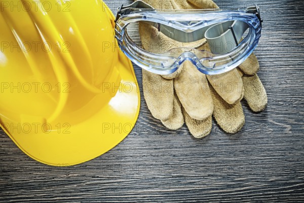 Safety goggles hard hat on wooden board