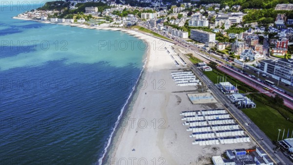 Aerial view on Le Havre Beach with white sand and cityscape: summer begin in normandy! Small white booths for beach accessories for residents of the city