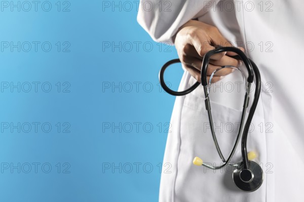 Close-up view of a hospital apron with a stethoscope in his hand