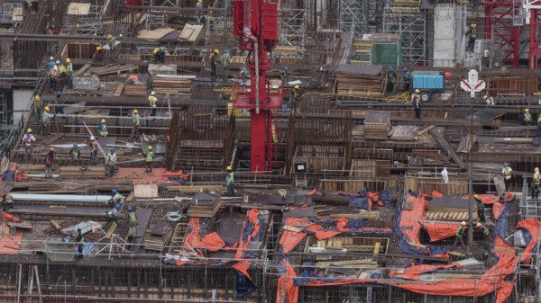 Workers busy with construction. Building a house in Kuala Lumpur, Malaysia