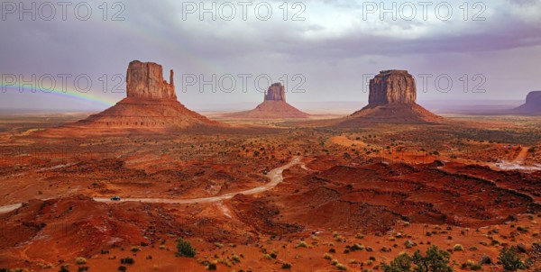 USA. Navajo Indian Reservations. The famous rock Mitten and the bright rainbow. Monument Valley is a unique geological formation in Arizona and Utah