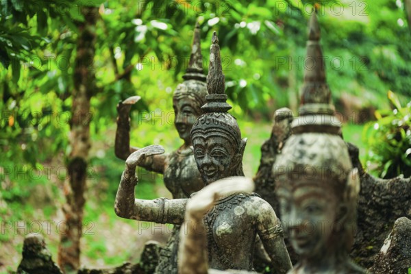 Weathered stone statues amidst green foliage in a forest setting, figures, stone figures, monuments, Tarnim Magic Garden Tambon Na Mueang, jungle, green, Ko Samui District, Thailand