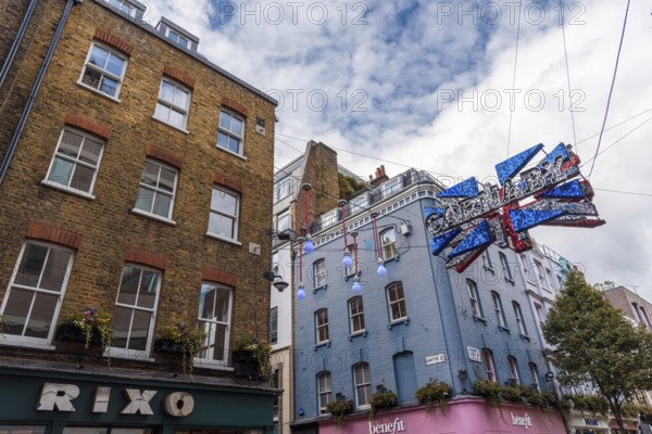 LONDON, UK, August 27, 2019: View of Carnaby Street. It is a pedestrianised shopping street in Soho in the City of Westminster. Carnaby sign