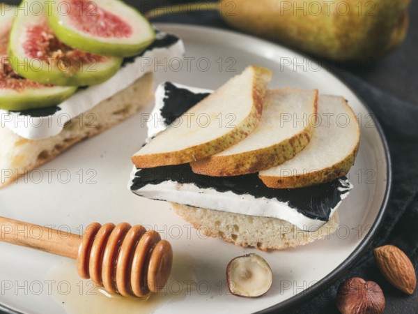Toast with black camembert cheese and pears slices on plate. Healthy snack or breakfast idea and reciepe