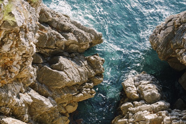 Rocks in the sea, waves hitting rocks.