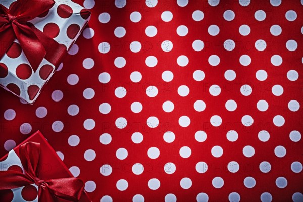Decorated gifts on polka-dot red table cloth holidays concept