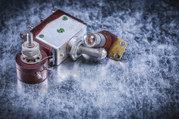 Electric toggle switch lamp-holder on metallic surface electricity concept