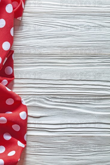 Red cotton polka-dot textile on wooden board