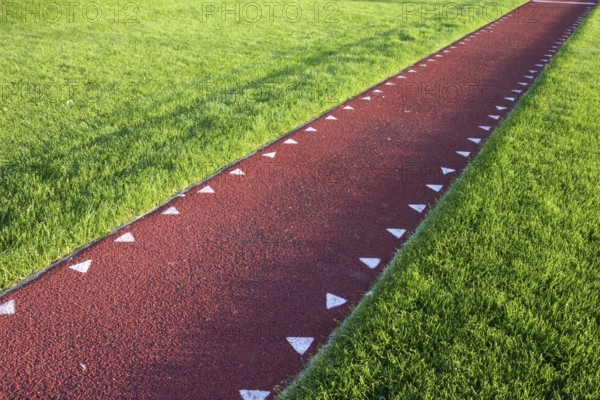 Running track with a red sysnthetic surface for a long jump competition