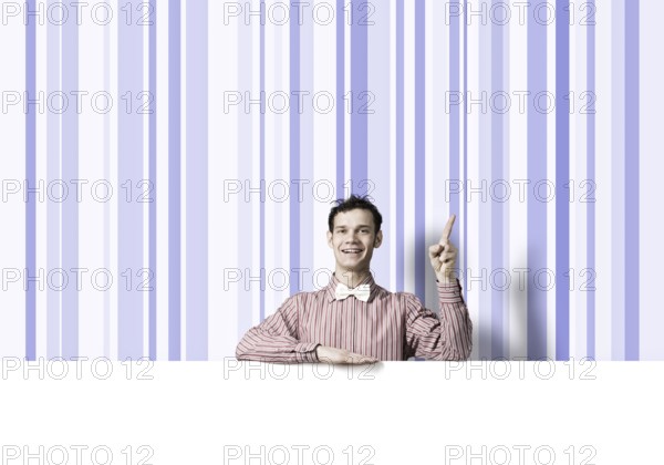 Young funny guy in checked shirt with banner pointing with finger up
