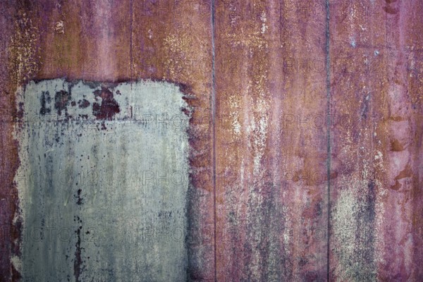 Rusty iron sheet with corrosion, selective focus, textured background
