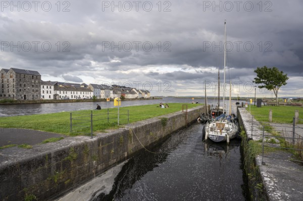 Boat anchored in Eglinton Canal Sea Lock, The Long Walk, Galway, Ireland, United Kingdom