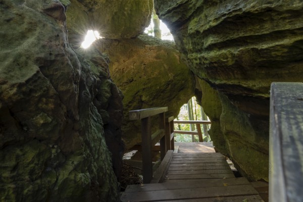 Narrow pass with rock holes, Mullerthal Trail, hiking trail near Berdorf, Luxembourg