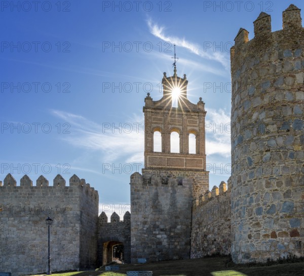 Avila, Spain, 8 April, 2024: view of the Avila city walls and the Puerta del Carmen with a sunstar