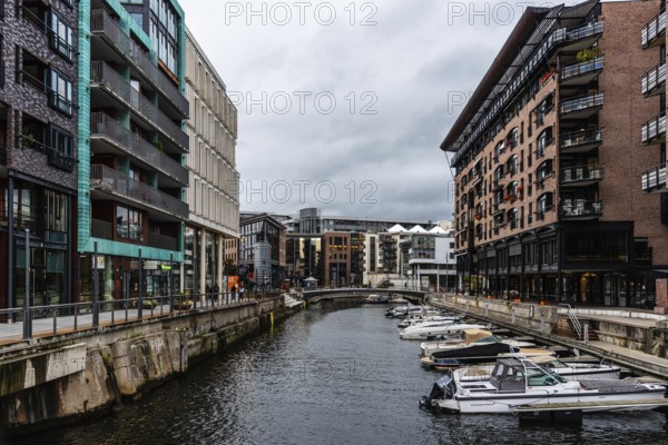 Oslo, Norway, August 11, 2019: Canal with boats in Tjuvholmen quarter, a new modern urban renewal with luxury housing in Central Oslo
